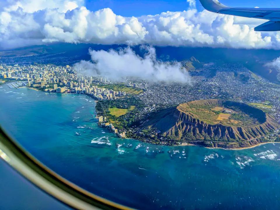 Diamond Head, Waikiki and the south shore of Oahu from the air, seen through an aircraft window